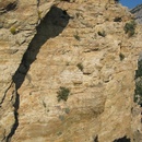 My shadow cast on a cliff face on Squaw Peak