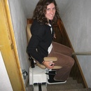 Kerry rides grandma's awesome chair down to the basement