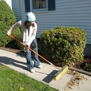 Jackie sweeps grandpa's yard